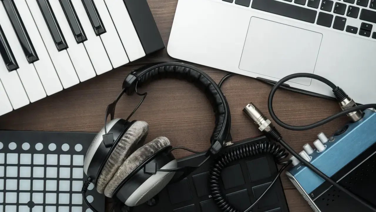 Clavier, casque, ordinateur portable et pads de batterie, idéal pour créer de la musique avec un logiciel beatmaking gratuit.