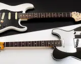 Stratocaster blanche et Telecaster noire, deux icônes Fender côte à côte. Le choix du guitariste entre ces deux légendes.