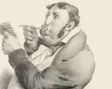Un homme soufflant dans une trompette, lisant une partition. Un jargon, une définition de ce terme.