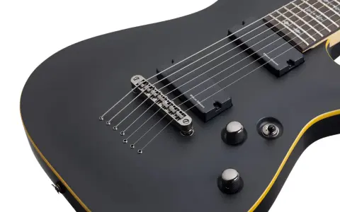 Guitare électrique Schecter Demon 7 noire, avec ses 7 cordes prêtes à rugir.